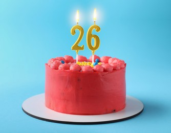 Image of Yummy cake with burning number shaped candles on light blue background. 26th birthday or other special occasion