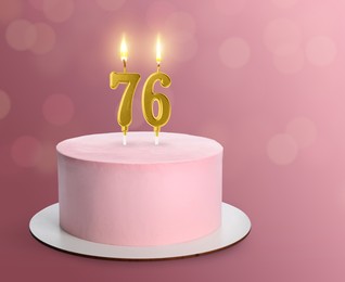 Image of Yummy cake with burning number shaped candles on lilac background, space for text. 76th birthday or other special occasion