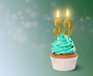 Image of Yummy cupcake with burning number shaped candles on turquoise background, space for text. 59th birthday or other special occasion
