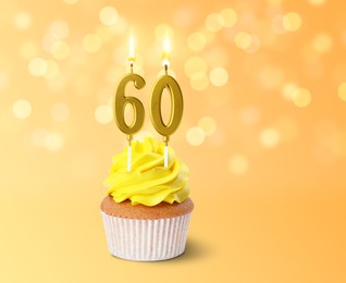 Image of Yummy cupcake with burning number shaped candles on color gradient background with blurred lights. 60th birthday or other special occasion