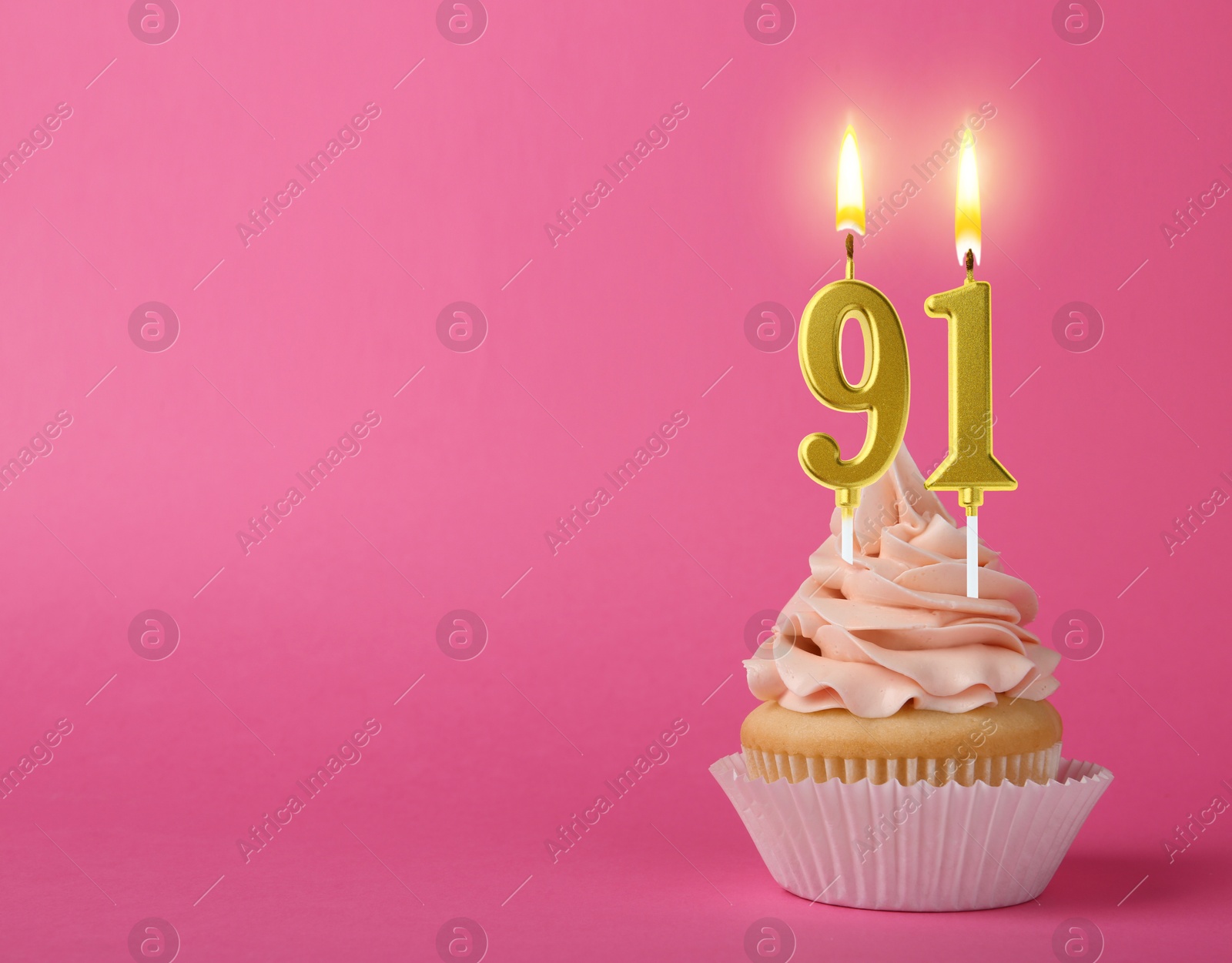 Yummy cupcake with burning number shaped candles on pink background, space for text. 91th birthday or other special occasion Image of Yummy cupcake with burning number shaped candles on pink background, space for text. 91th birthday or other special occasion