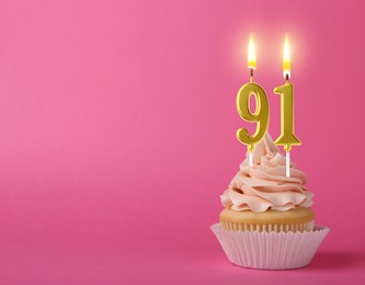 Image of Yummy cupcake with burning number shaped candles on pink background, space for text. 91th birthday or other special occasion
