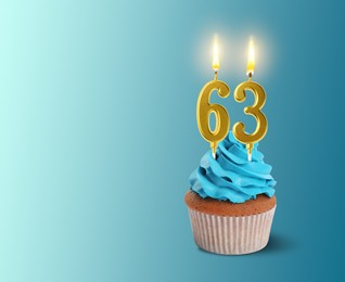 Image of Yummy cupcake with burning number shaped candles on light blue gradient background, space for text. 63th birthday or other special occasion