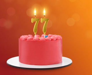 Image of Yummy cake with burning number shaped candles on color gradient background. 77th birthday or other special occasion