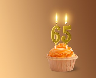 Image of Yummy cupcake with burning number shaped candles on light brown gradient background, space for text. 65th birthday or other special occasion