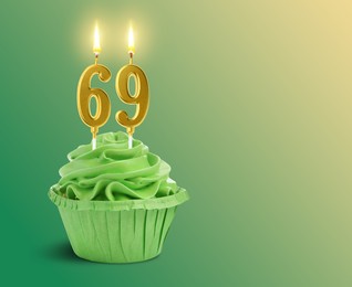 Image of Yummy cupcake with burning number shaped candles on green gradient background, space for text. 69th birthday or other special occasion