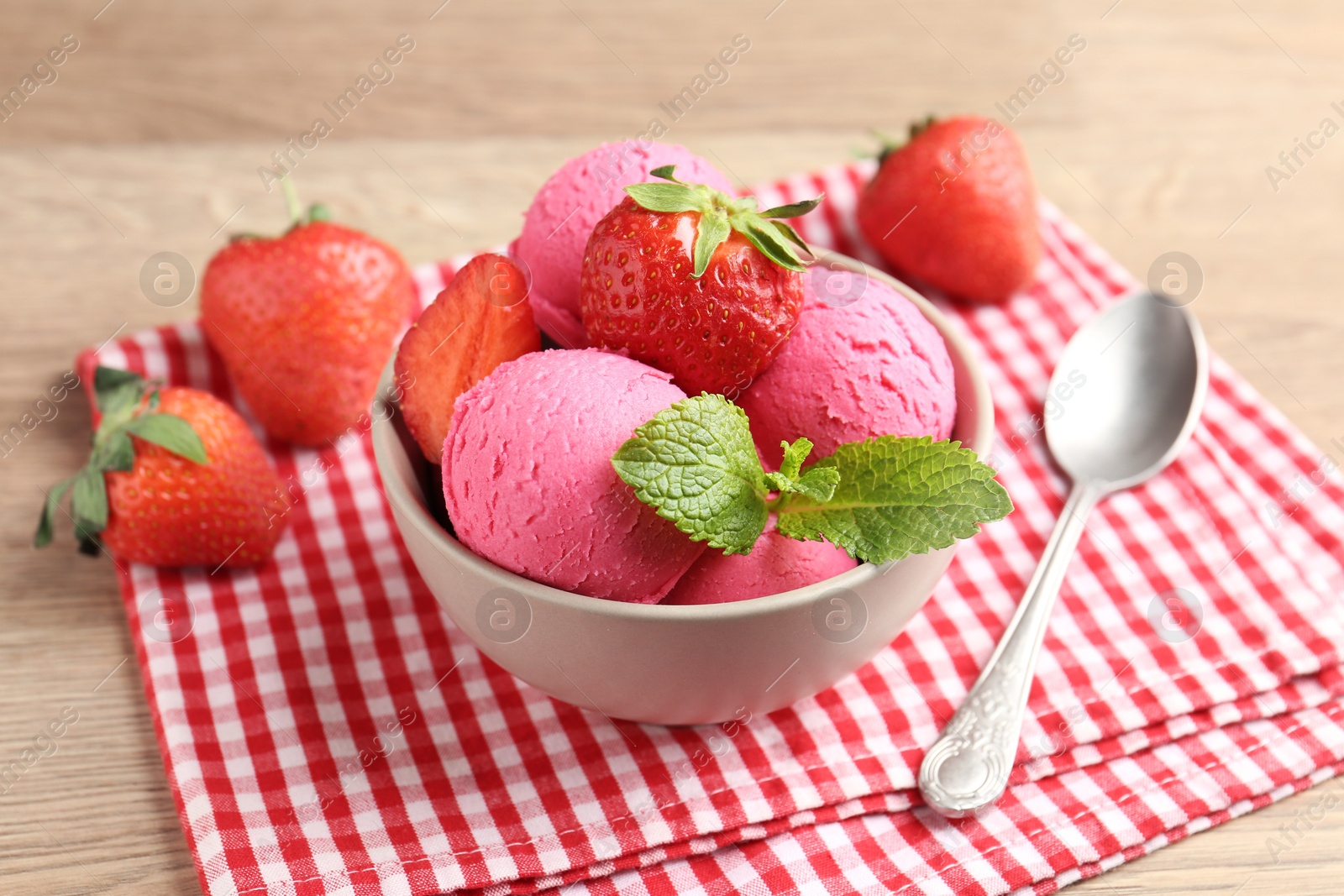 Refreshing sorbet, strawberries and mint on wooden table, closeup Photo of Refreshing sorbet, strawberries and mint on wooden table, closeup