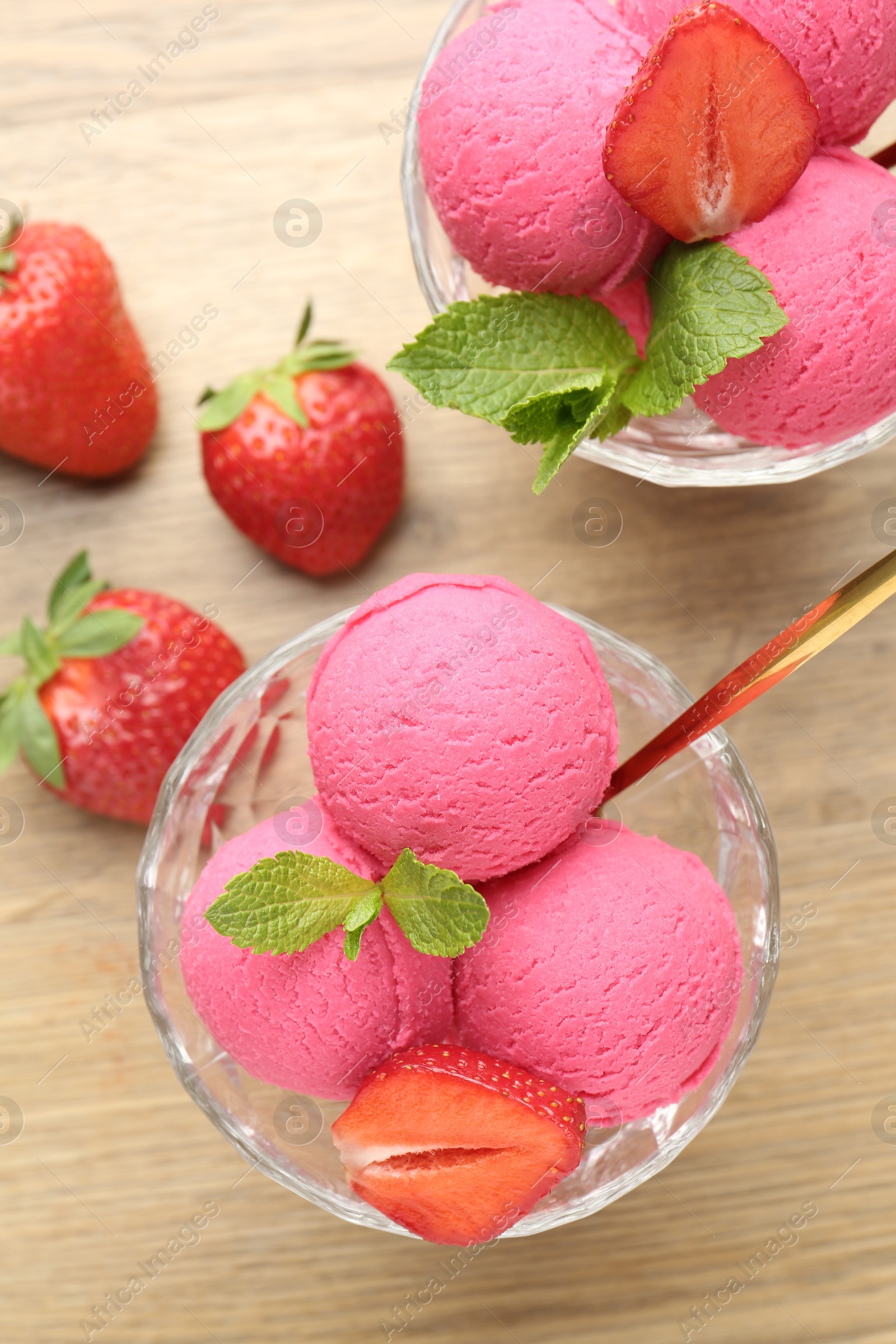 Refreshing sorbet, strawberries and mint on wooden table, flat lay Photo of Refreshing sorbet, strawberries and mint on wooden table, flat lay