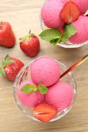 Photo of Refreshing sorbet, strawberries and mint on wooden table, flat lay