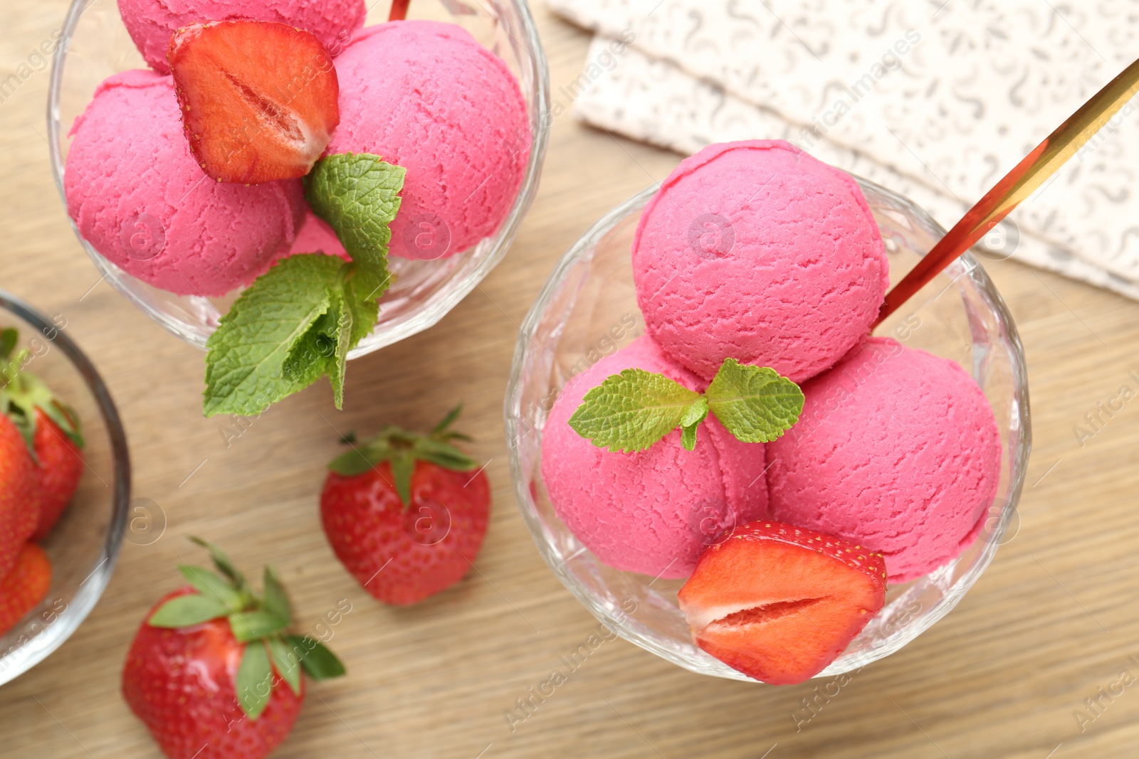 Refreshing sorbet, strawberries and mint on wooden table, flat lay Photo of Refreshing sorbet, strawberries and mint on wooden table, flat lay