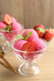 Photo of Refreshing sorbet, strawberries and mint on wooden table, closeup