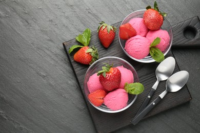 Photo of Refreshing sorbet, strawberries and mint on grey textured table, top view. Space for text