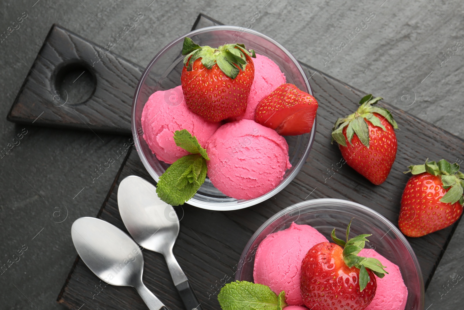Refreshing sorbet, strawberries and mint on grey textured table, top view Photo of Refreshing sorbet, strawberries and mint on grey textured table, top view