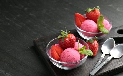 Photo of Refreshing sorbet, strawberries, mint and spoons on grey textured table, closeup. Space for text
