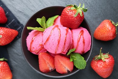 Photo of Refreshing sorbet with syrup, strawberries and mint in bowl on grey textured table, flat lay
