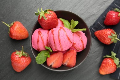 Photo of Refreshing sorbet with syrup, strawberries and mint in bowl on grey textured table, flat lay