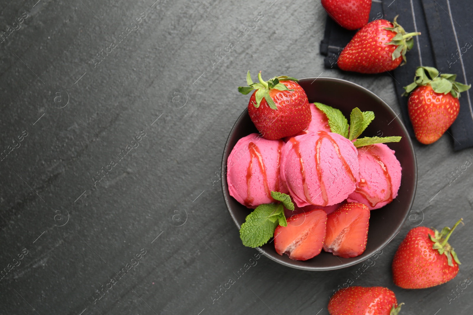 Refreshing sorbet with syrup, strawberries and mint in bowl on grey textured table, flat lay. Space for text Photo of Refreshing sorbet with syrup, strawberries and mint in bowl on grey textured table, flat lay. Space for text