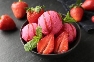 Photo of Refreshing sorbet with syrup, strawberries and mint in bowl on grey textured table, closeup