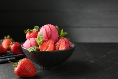Photo of Refreshing sorbet with syrup, strawberries and mint in bowl on grey textured table, closeup