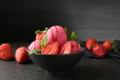 Photo of Refreshing sorbet with syrup, strawberries and mint in bowl on grey textured table, closeup