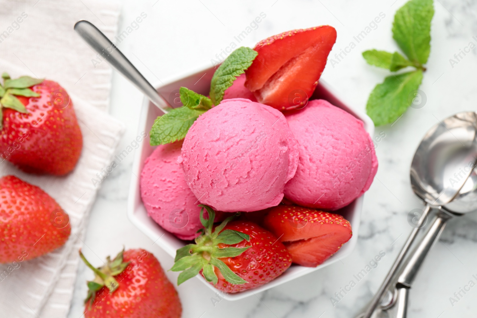 Refreshing sorbet, strawberries and mint in bowl on white marble table, flat lay Photo of Refreshing sorbet, strawberries and mint in bowl on white marble table, flat lay