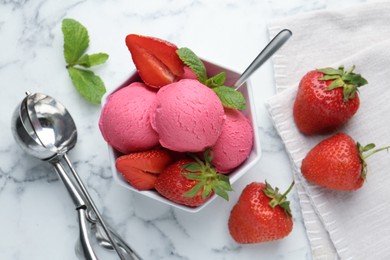 Photo of Refreshing sorbet, strawberries and mint in bowl on white marble table, flat lay