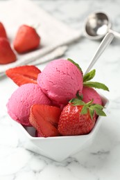 Photo of Refreshing sorbet, strawberries and mint in bowl on white marble table, closeup
