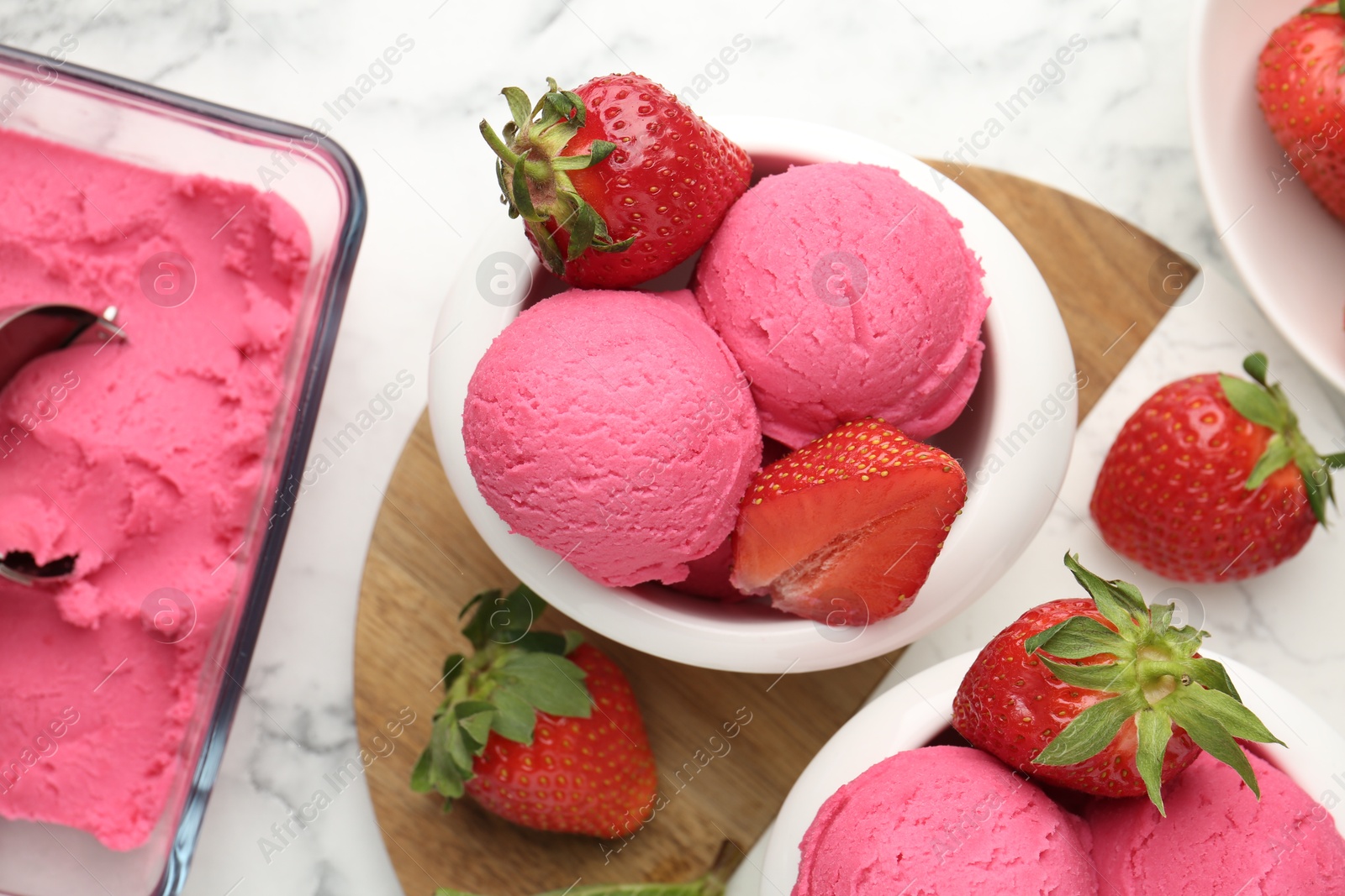 Refreshing sorbet, strawberries and mint on white marble table, flat lay Photo of Refreshing sorbet, strawberries and mint on white marble table, flat lay