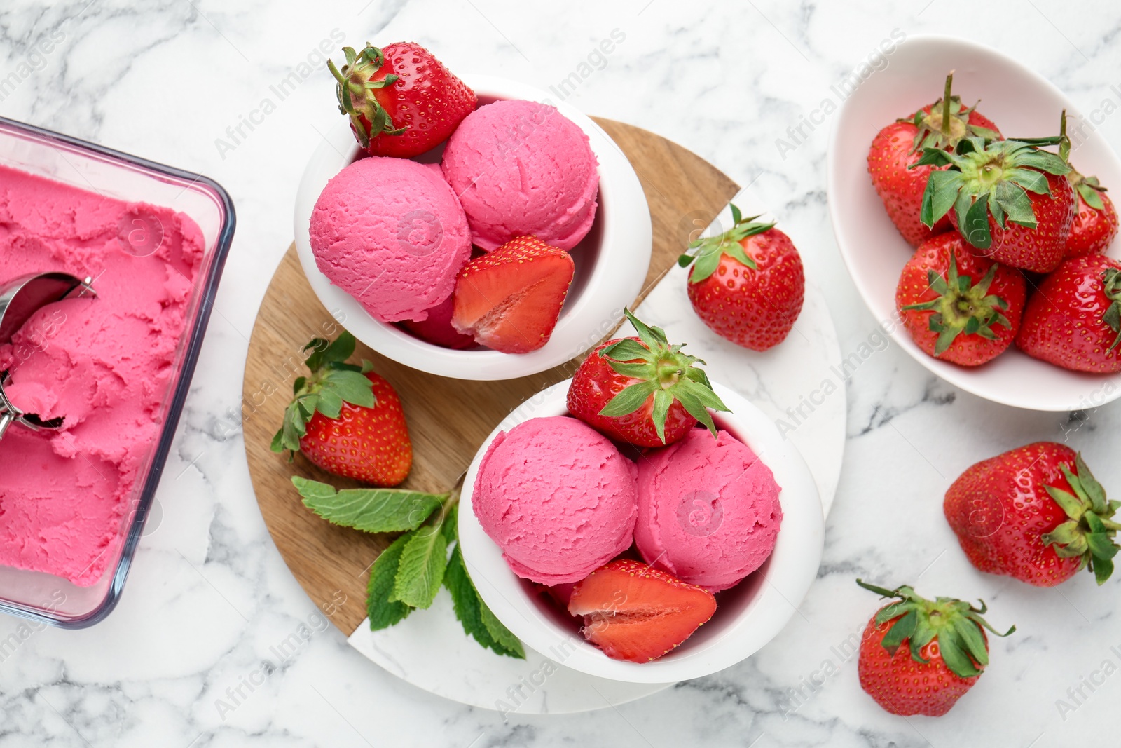 Refreshing sorbet, strawberries and mint on white marble table, flat lay Photo of Refreshing sorbet, strawberries and mint on white marble table, flat lay