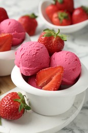 Photo of Refreshing sorbet and strawberries on white marble table, closeup