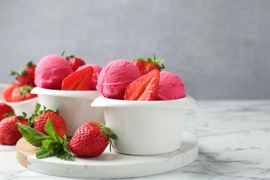 Photo of Refreshing sorbet, strawberries and mint on white marble table against grey background, closeup