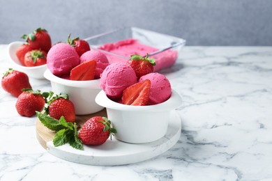 Photo of Refreshing sorbet, strawberries and mint on white marble table against grey background, closeup