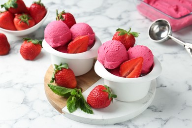 Photo of Refreshing sorbet, strawberries and mint on white marble table, closeup