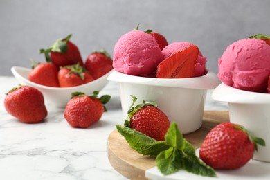 Photo of Refreshing sorbet, strawberries and mint on white marble table against grey background, closeup