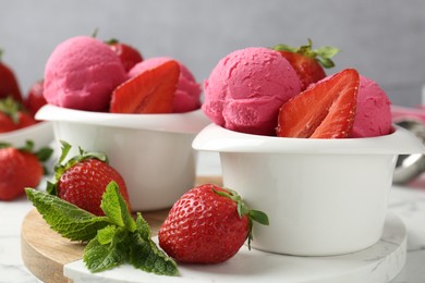 Photo of Refreshing sorbet, strawberries and mint on white marble table against grey background, closeup