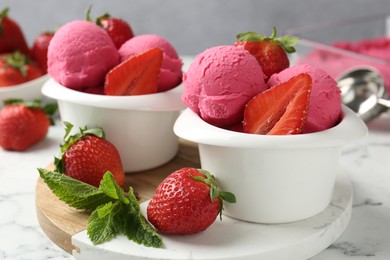 Photo of Refreshing sorbet, strawberries and mint on white marble table against grey background, closeup