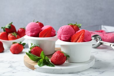 Photo of Refreshing sorbet, strawberries and mint on white marble table against grey background, closeup