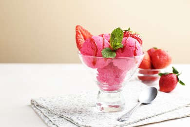Photo of Refreshing sorbet with syrup, strawberries and mint in dessert bowl on white table against beige background, closeup. Space for text