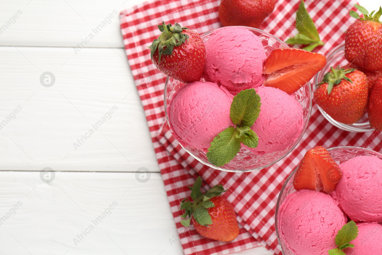 Refreshing sorbet, strawberries and mint on white wooden table, top view. Space for text Photo of Refreshing sorbet, strawberries and mint on white wooden table, top view. Space for text