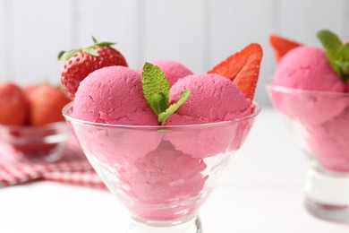 Photo of Refreshing sorbet, strawberries and mint in dessert bowl on white table, closeup