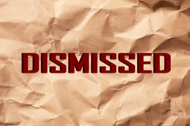 Image of Word Dismissed on crumpled paper as background
