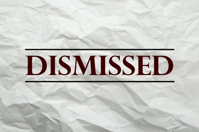 Image of Word Dismissed on crumpled paper as background