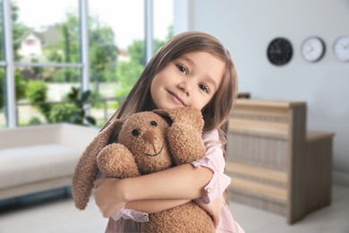 Image of Cute little girl with toy bunny in lobby of children's hospital