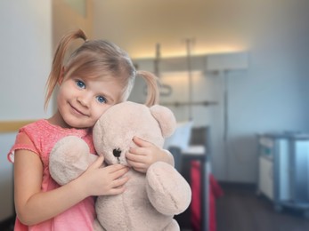 Image of Cute little girl with toy bear in children's hospital