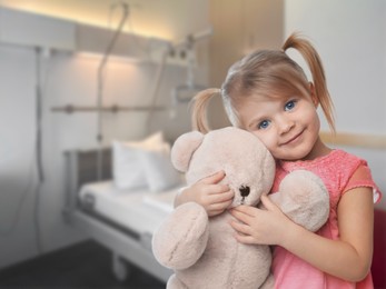 Image of Cute little girl with toy bear in children's hospital
