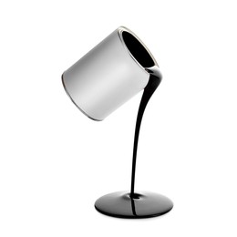 Image of Black paint pouring out of can on white background