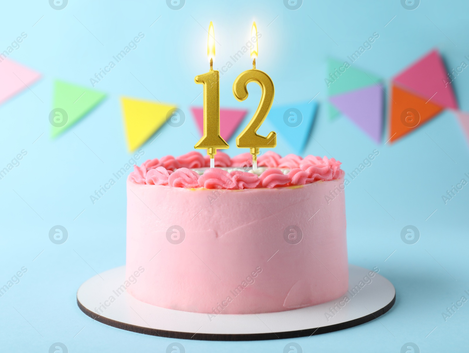 Yummy cake with burning number shaped candles on light blue background. 12th birthday or other special occasion Image of Yummy cake with burning number shaped candles on light blue background. 12th birthday or other special occasion