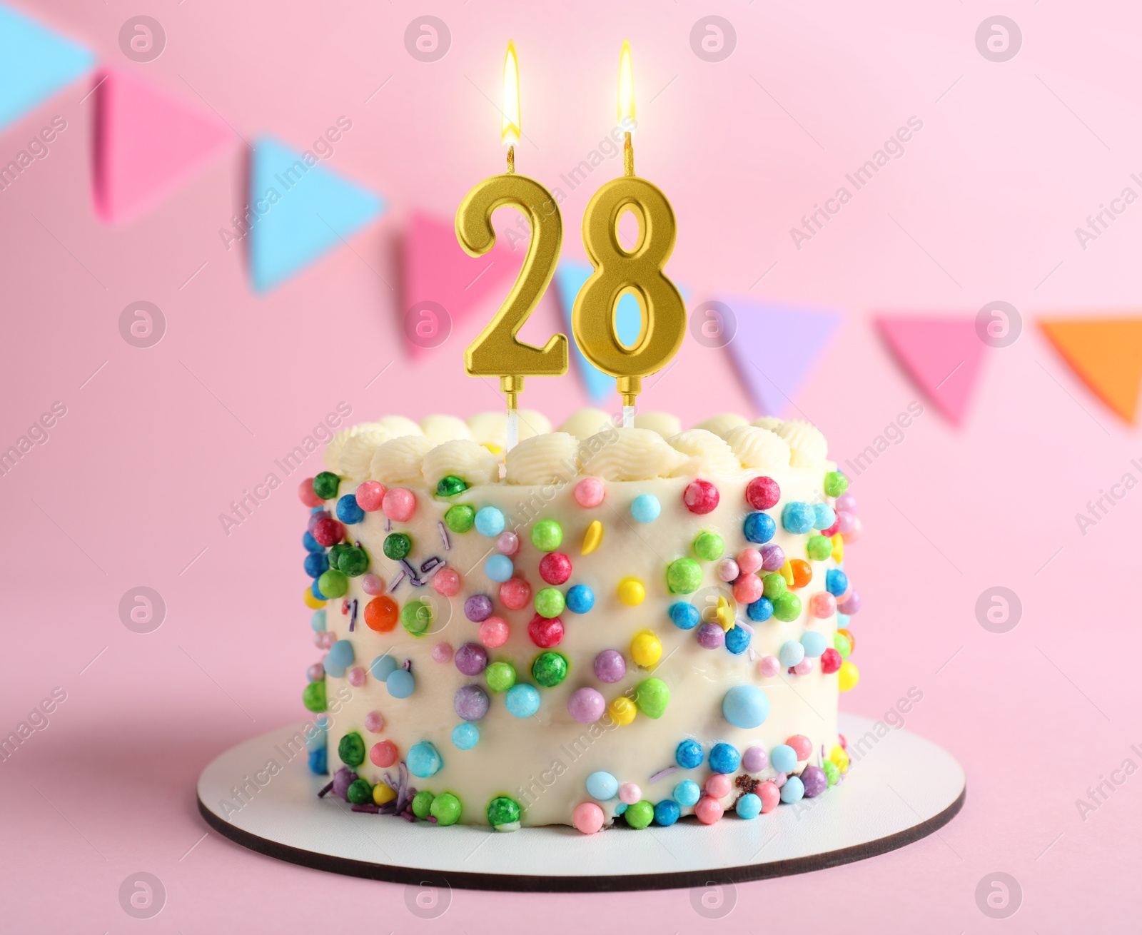 Yummy cake with burning number shaped candles on pink background. 28th birthday or other special occasion Image of Yummy cake with burning number shaped candles on pink background. 28th birthday or other special occasion