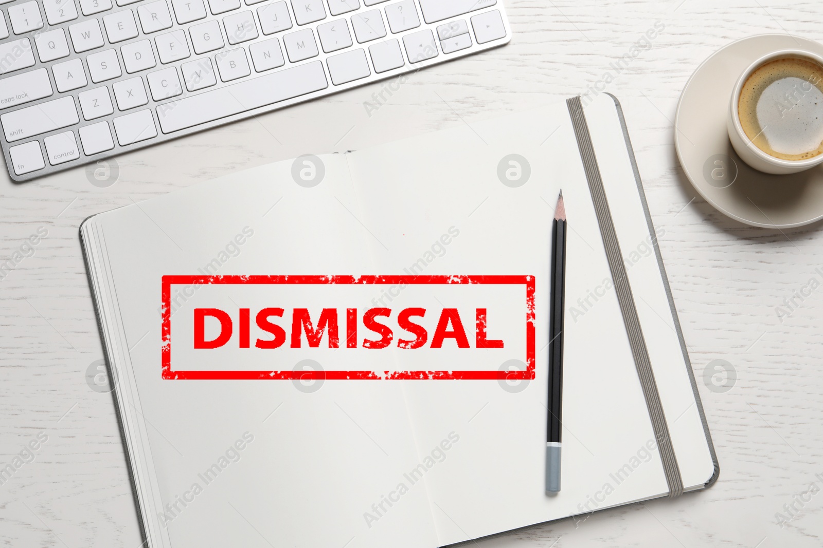 Red stamp Dismissal in notebook on white wooden table, top view Image of Red stamp Dismissal in notebook on white wooden table, top view