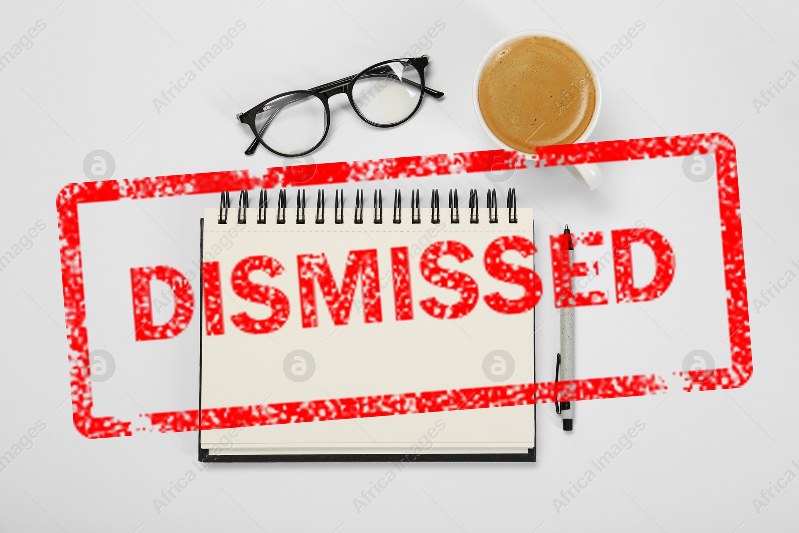 Red stamp Dismissed over notebook on white table, top view Image of Red stamp Dismissed over notebook on white table, top view